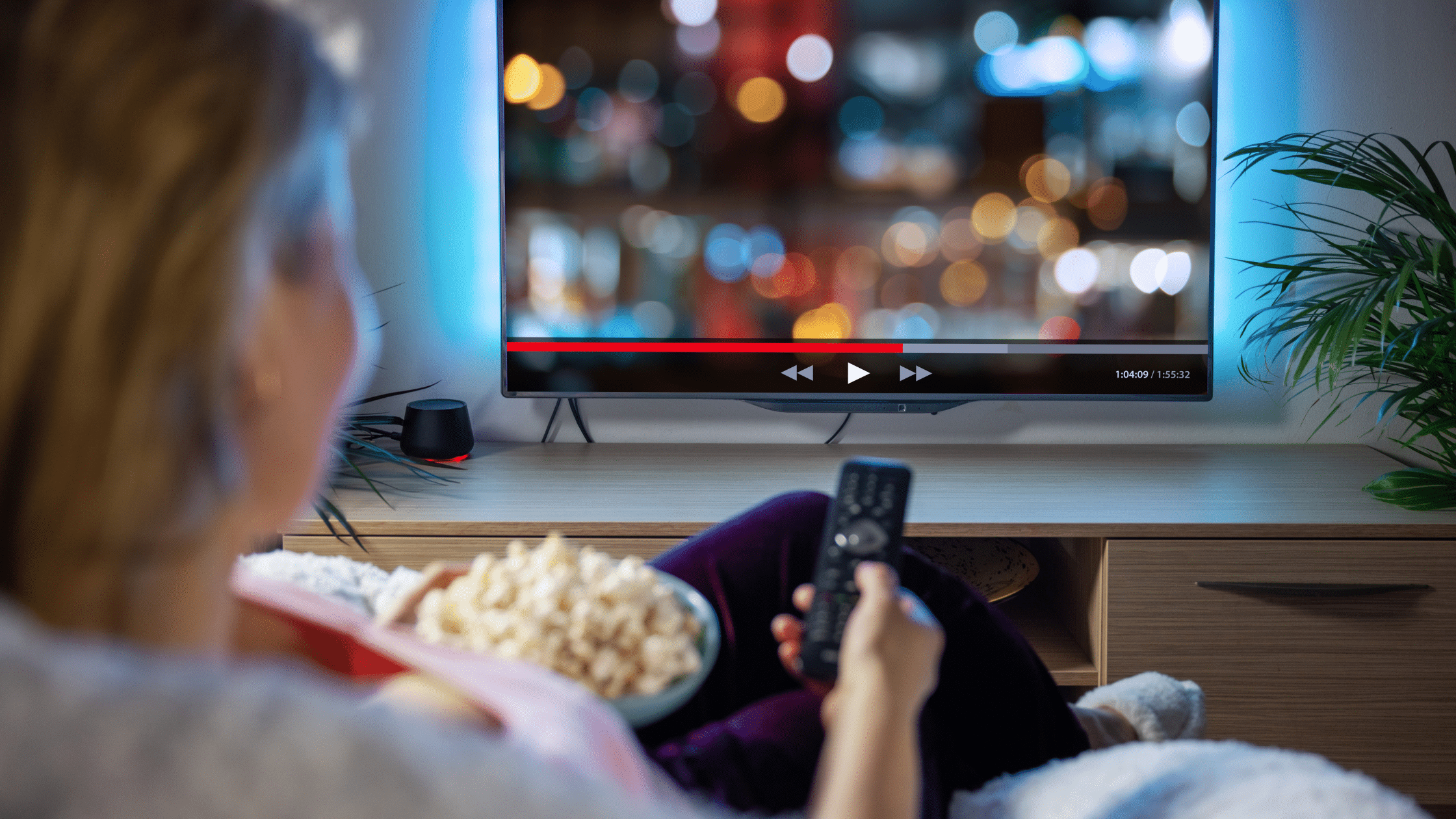 Unleashing the Power of Streaming Ads: Why Your Business Needs Them oman in front of a tv streaming a movie