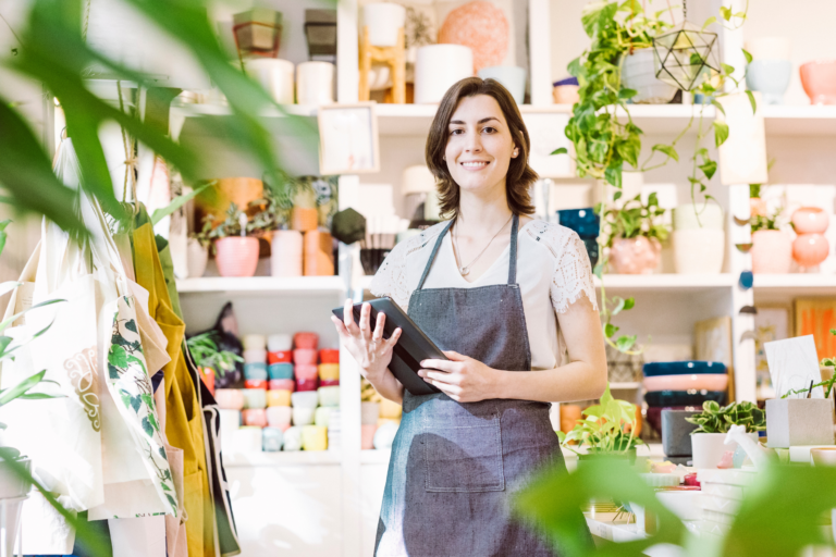 5 Essential Digital Marketing Strategies to Boost Small Business Sales woman in retail store holding a tablet